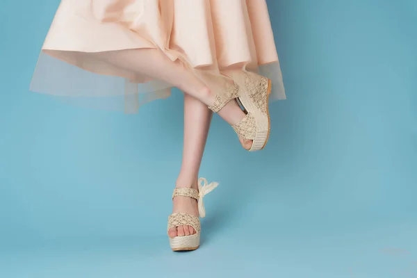 Женские ноги в обуви платье позируя моды синий фон — стоковое фото