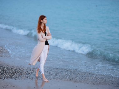 Kadınlar kıyı boyunca yürür. Okyanus manzarası tatil akşamları romantizm.