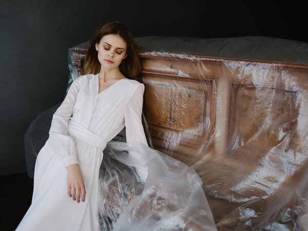 beautiful woman in white dress leaning on the piano posing luxury
