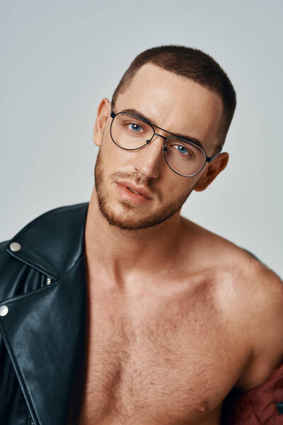 man in black leather jacket topless posing modern style self-confidence