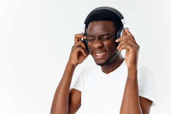 Man in headphones listening to music emotions white t-shirt studio fun — Stock Fotó