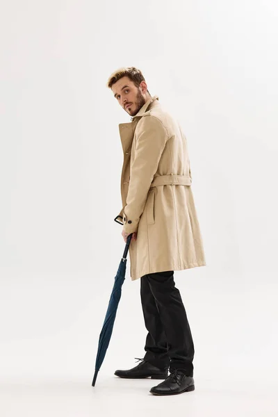 Man beige coat umbrella rain protection autumn style — Fotografia de Stock