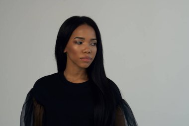 Afrikalı kadın görünüşü ve uzun koyu renk saçlar açık renk arka plan