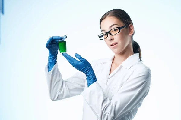 laboratory assistant in white coat chemical solution analyzes professional science