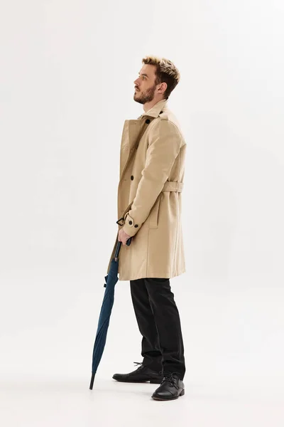 stock image man in beige coat rain umbrella lifestyle posing