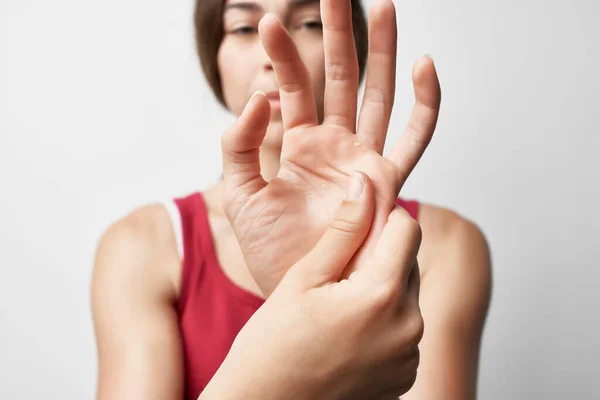 Woman holding hand finger pain treatment medicine — Stock Photo, Image