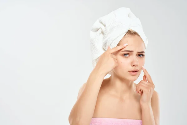 Woman with towel on head health clean skin point on face — Stock Photo, Image