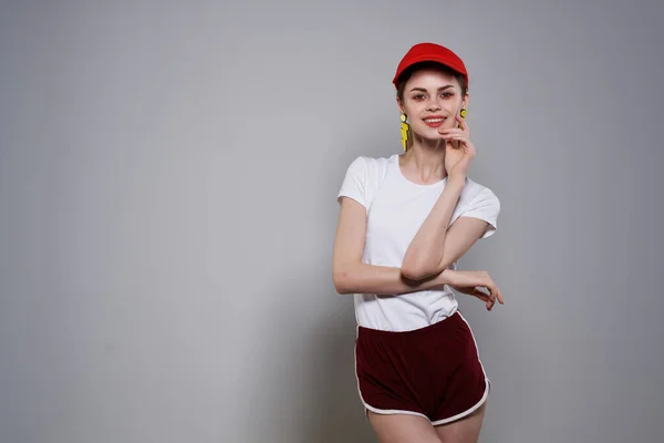 Aranyos vicces lány piros sapkában nyári ruhák divat fülbevaló ékszerek — Stock Fotó