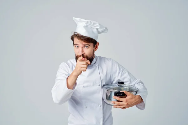 male chef with white hat on his head in  restaurant kitchen