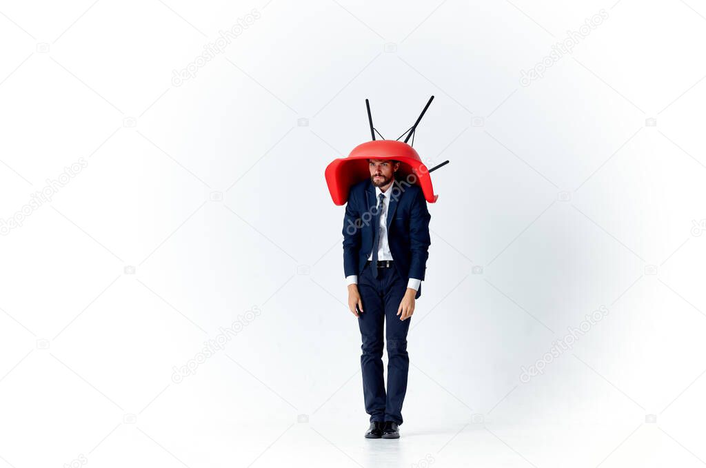 man in suit with  red chair on  light background. High quality photo