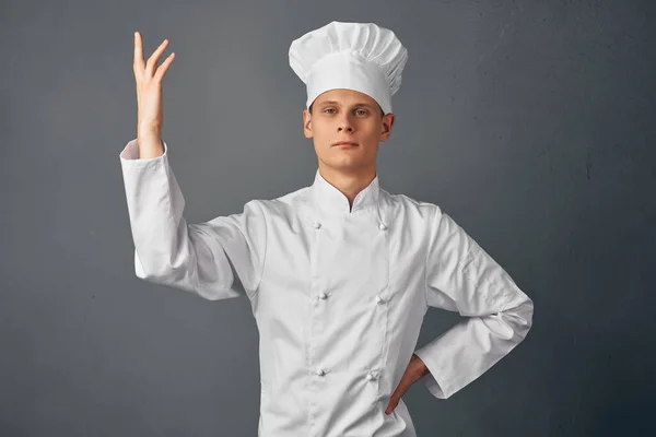 chef with a cap on his head gesturing with his hands work profession