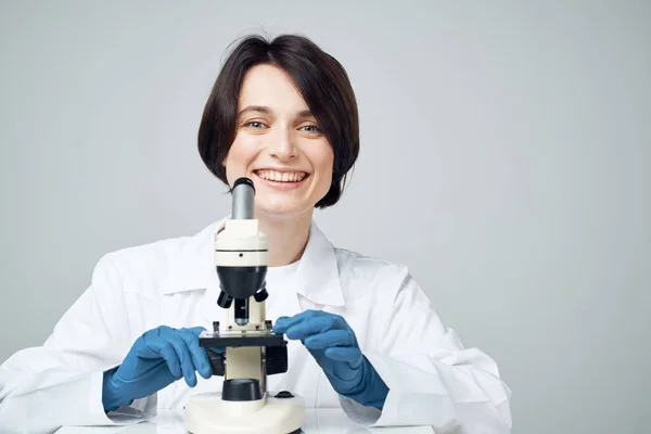 doctor laboratory assistant microscope on research table smile
