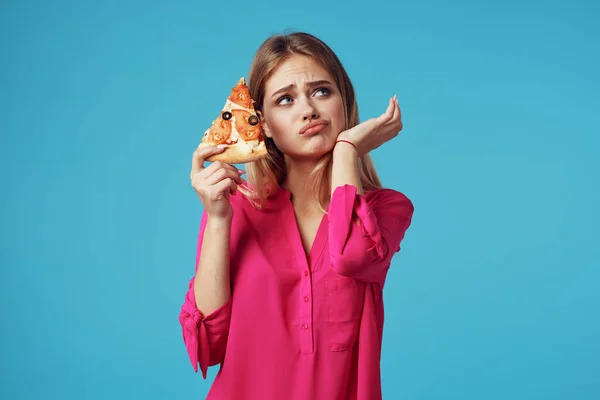 Mujer en rosa camisa pizza celebración comida rápida dieta azul fondo — Foto de Stock