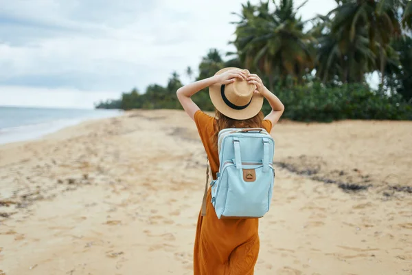 Kvinna turist med ryggsäck promenader på stranden semester frihet — Stockfoto