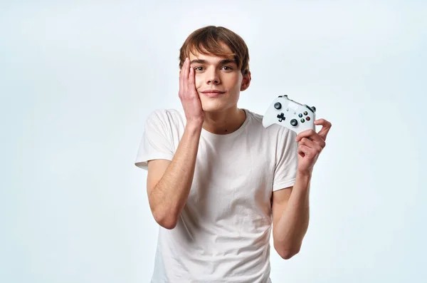 Guy in a white t-shirt joystick hands playing entertainment — Stock Photo, Image