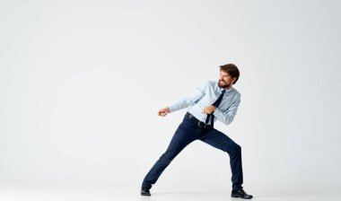 Tişörtlü iş adamı bir şey çekiyor.