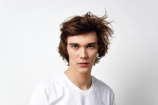 Cute guy in white t-shirt tousled hair emotions posing — Stock Photo, Image