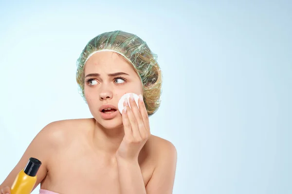Woman wipes face with lotion naked shoulders skin care cosmetology — Stock Photo, Image