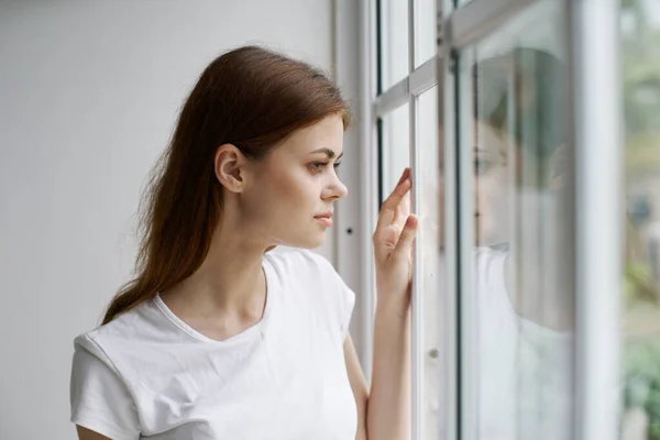 Woman looking out the window pensive view morning interior — Stock Photo, Image