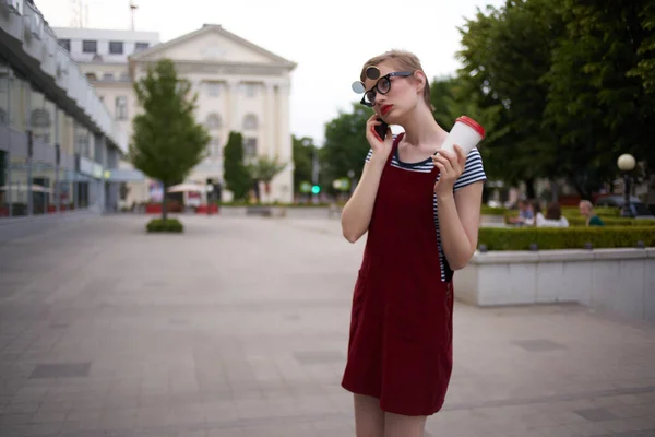 Žena s krátkými vlasy a sklenicí kávy chůze venku čerstvý vzduch — Stock fotografie