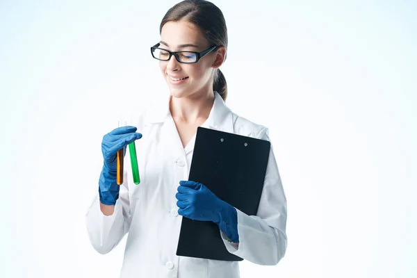 Cheerful woman laboratory assistant chemical solution analyzes research light background — Stock Photo, Image