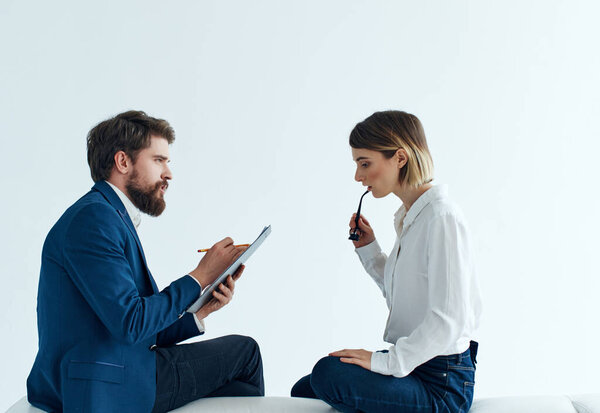 man and woman sitting on the couch communication work discussion