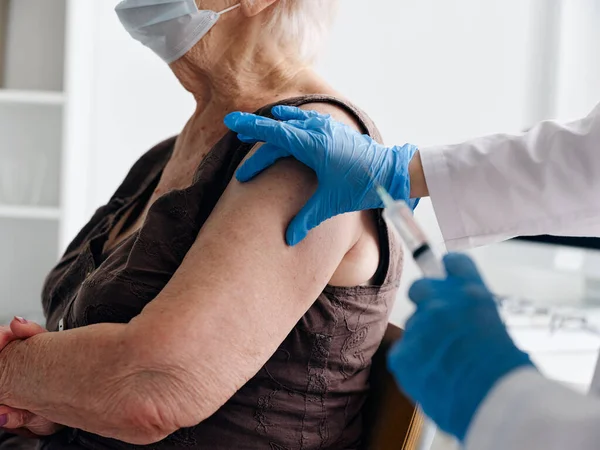 elderly woman patient coronavirus vaccine shot close-up