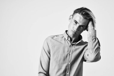 Tişörtlü, saç stili, çekici portre pozu veren bir adam.