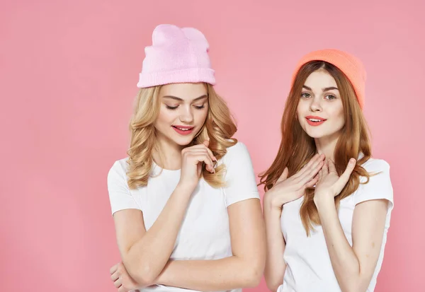 Namoradas alegres em camisetas brancas depois de roupas abraço amizade rosa fundo — Fotografia de Stock