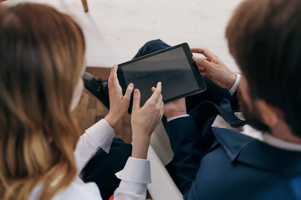 man and woman in business suits work with a tablet managers professionals