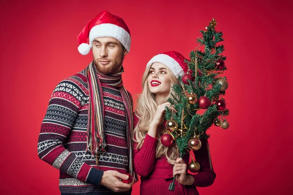 Милый мужчина и женщина Новый год украшения елки праздник красный фон — стоковое фото
