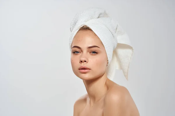 头戴毛巾的妇女裸肩白皙的皮肤健康的浅色背景 — 图库照片
