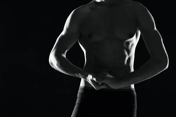 A man in black panties with a pumped-up body black and white photo — Stock Photo, Image