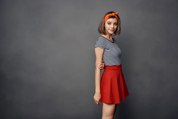 woman in striped t-shirt with orange headband fashion glamor