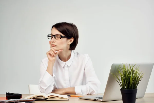 Zakelijke vrouw in wit shirt zit aan het werk tafel in de voorkant van laptop kantoor — Stockfoto