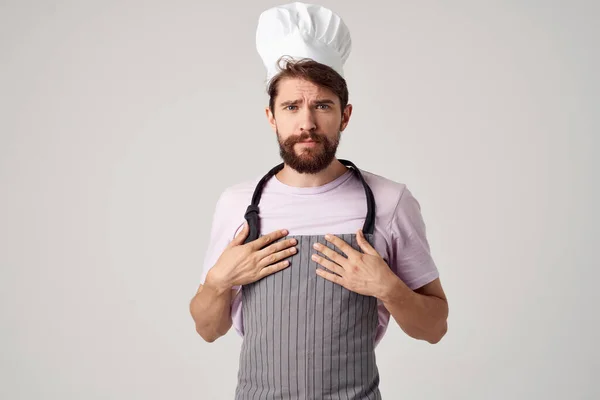 Man in a chefs cap apron work as a cook restaurant kitchen — Stock Photo, Image