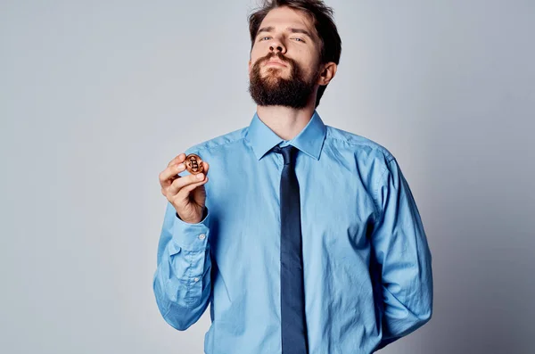 Un hombre con una camisa con un bitcoin criptomoneda corbata en las manos de un gestor de inversiones de Internet — Foto de Stock