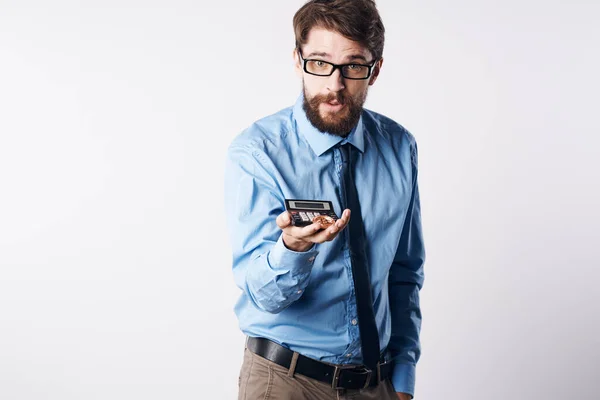 A man in a blue shirt with a calculator in his hands finance Professional — Stock Photo, Image