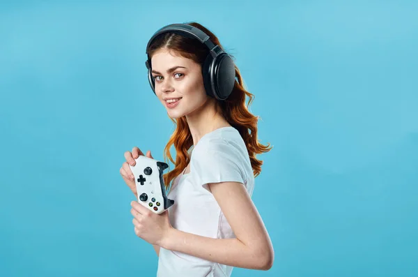 Woman in headphones with a joystick in her hands plays video games — Stock Photo, Image