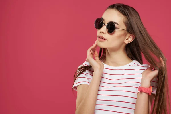 Pretty woman wearing glasses striped tshirt styles posing pink background — Stock Photo, Image