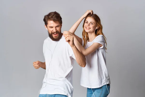 Young couple in white t-shirts friendship fun modern style — Stock Photo, Image