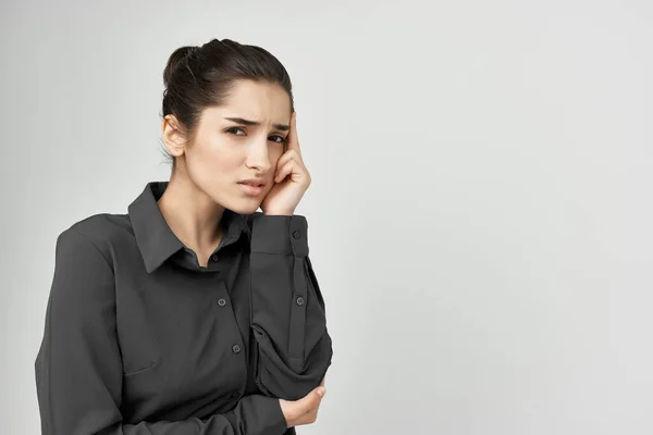 woman in black shirt holding her head pain problems emotions stress