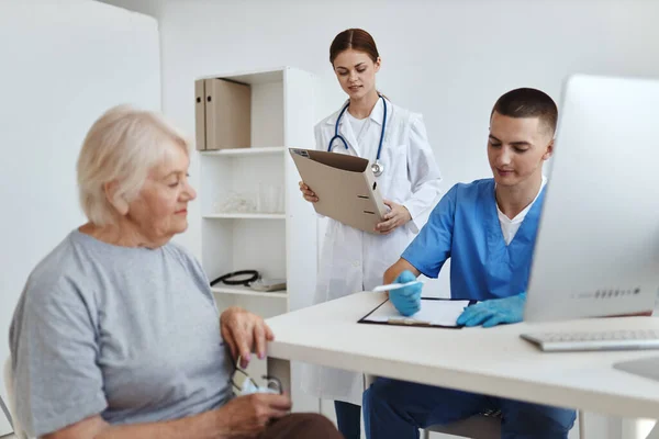 Una enfermera y un médico examinando a un paciente en un hospital diagnósticos de salud —  Fotos de Stock