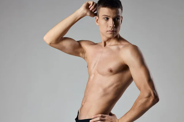 Sexy athletes with pumped up arm muscles on gray background cropped view — Stock Photo, Image
