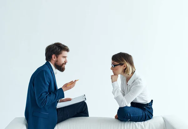 man and woman sitting on the couch communication work discussion