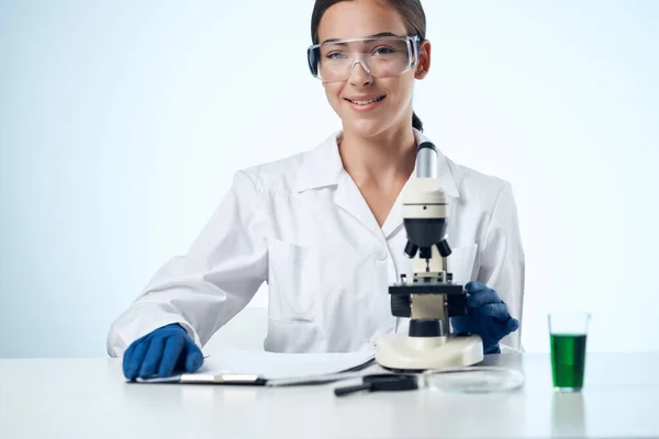 female doctor laboratory microscope technology research science
