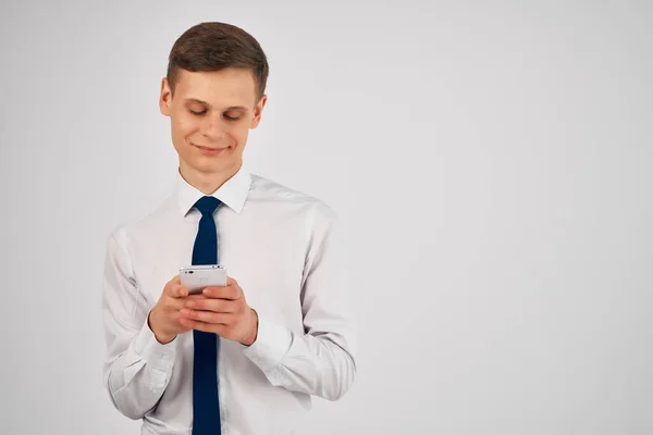 business man in shirt with tie phone in hands technology office