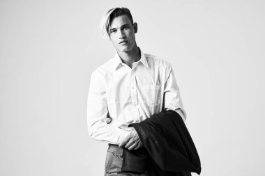 Omuzlarının üzerinde ceketi olan bir adam. Moda stüdyosu modeli.