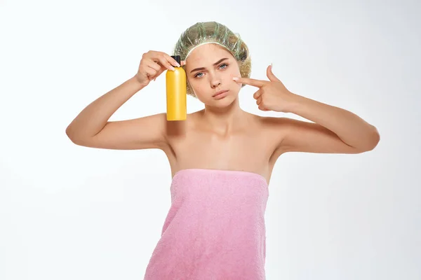 Vrouw met roze handdoek naakt ringlets crème huidverzorging licht achtergrond — Stockfoto