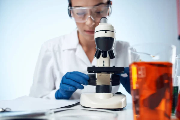 woman scientist laboratory microscope diagnostics chemical solution analyzes